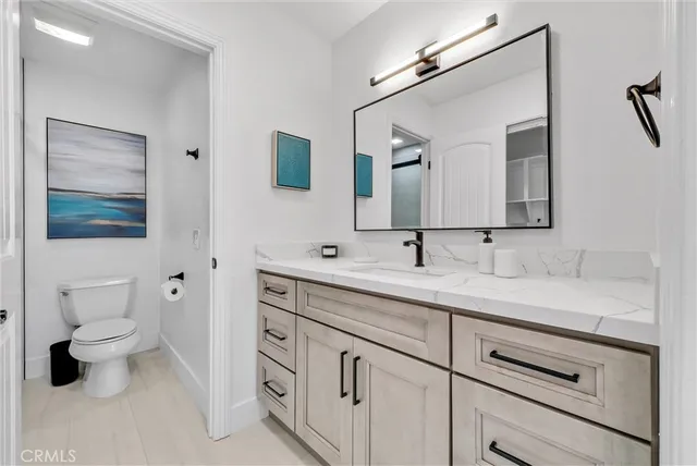 a spacious bedroom with a bed and a chair