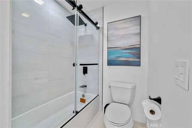 a spacious bedroom with a bed a couch and a window