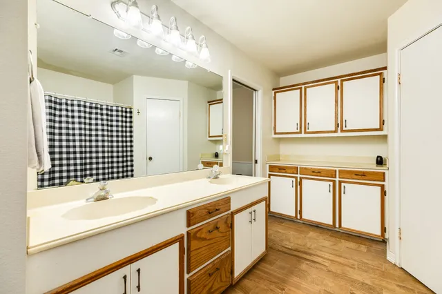 a bathroom with a sink double vanity and a bathtub