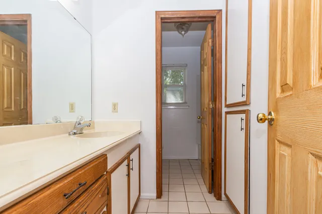 a bathroom with a sink a mirror and a shower