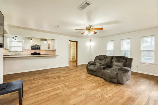 a living room with furniture and kitchen view