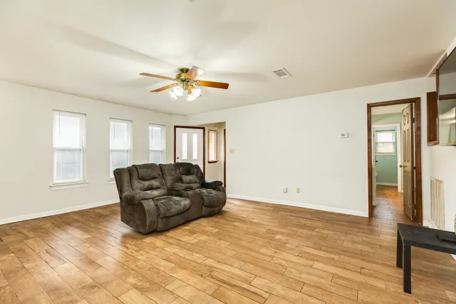 a living room with furniture and a chandelier