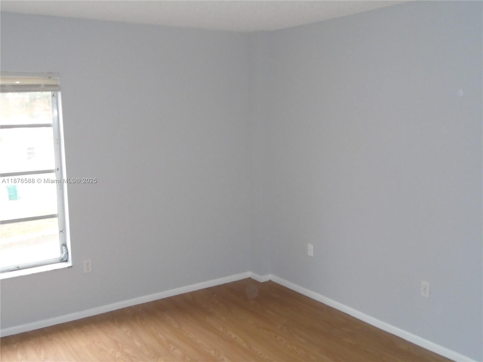 4176 Inverrary Drive, Unit 209 Lauderhill, FL 33319 - Photo 13 of 15 an empty room with a window