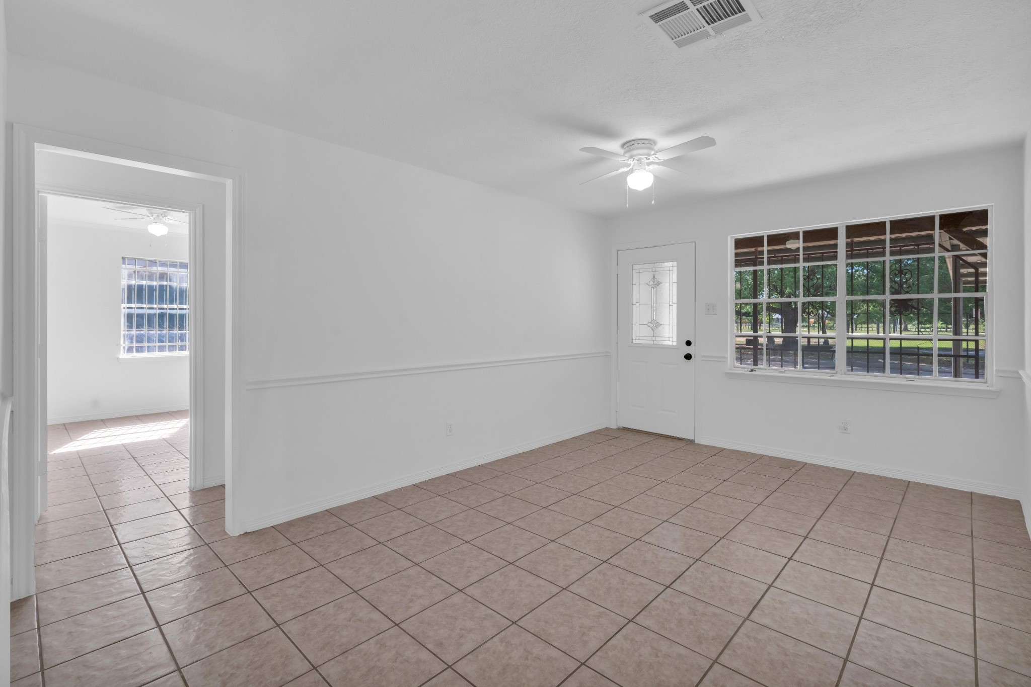 3922 Simsbrook Drive Houston, TX 77045 - Photo 12 of 32 View of the living room from the kitchen, toward the home's main entry. Primary Bedroom entrance shown to the left.