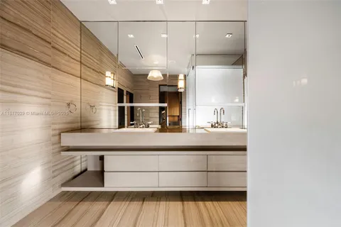 a bathroom with a glass shower door and a sink