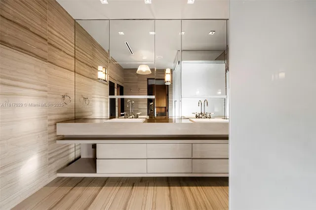 a bathroom with a glass shower door and a sink