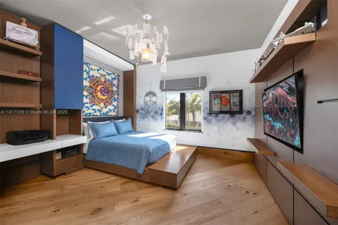 a bedroom with furniture and a chandelier