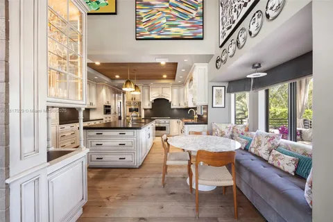 a kitchen with stainless steel appliances granite countertop a sink a stove and cabinets