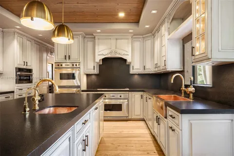 a kitchen with stainless steel appliances granite countertop a sink and a stove