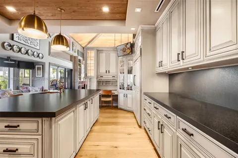 a large kitchen with stainless steel appliances a large counter top