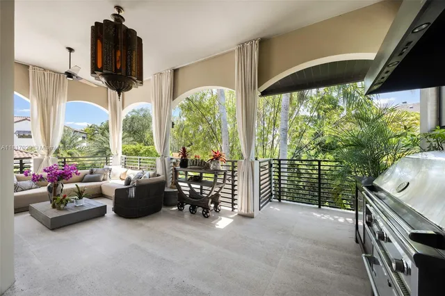 a living room with furniture and floor to ceiling windows