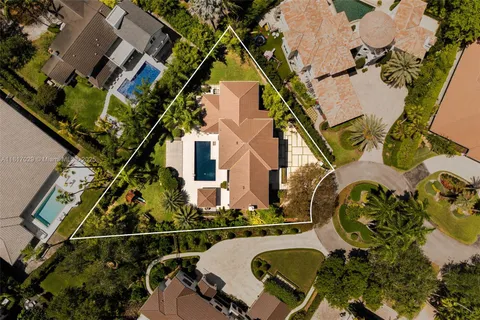 an aerial view of residential house with outdoor space and parking