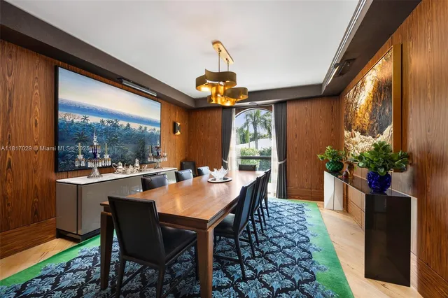 a dining room with furniture a chandelier and window