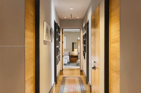 a spacious bedroom with a bed lamp and a large window