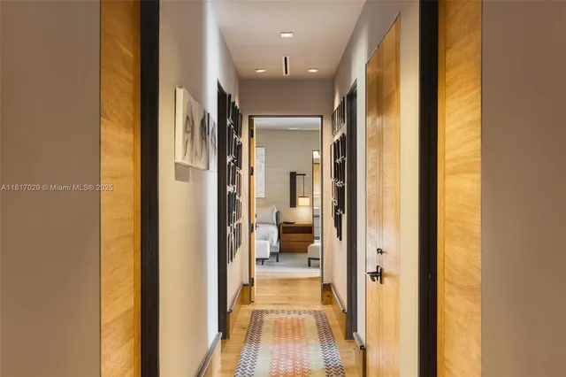 a spacious bedroom with a bed lamp and a large window