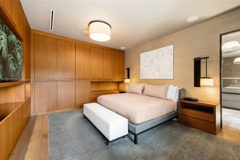 a bedroom with a large bed couch and a window