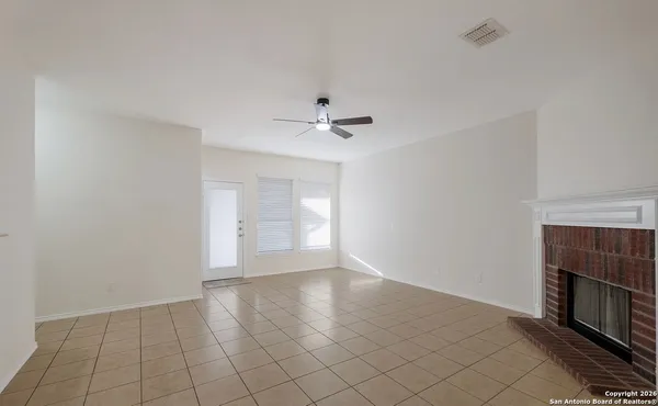 wooden floor in an empty room with a fireplace