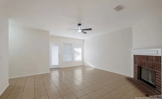 wooden floor in an empty room with a fireplace