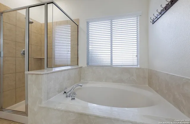 a bathroom with a bathtub and window