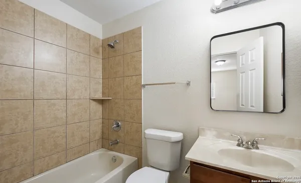 a bathroom with a sink shower and a toilet