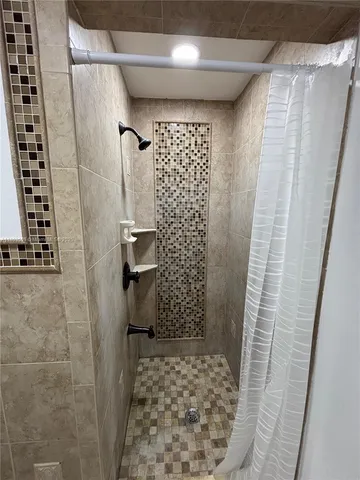 a bathroom with a shower and a sink