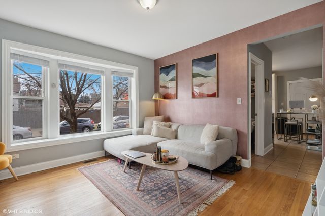 a living room with furniture a table and a large window