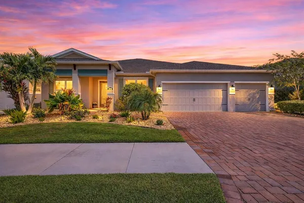 a front view of a house with a garden and yard