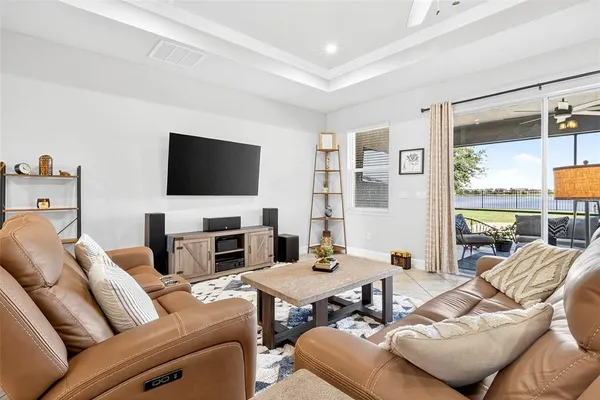 a spacious bedroom with a bed and a flat screen tv