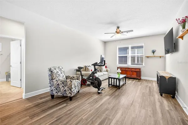 a living room with furniture and a floor to ceiling window