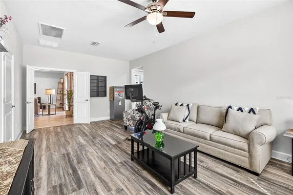 a dining room with furniture a flat screen tv and a large window