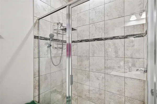 an aerial view of ocean and residential houses with outdoor space