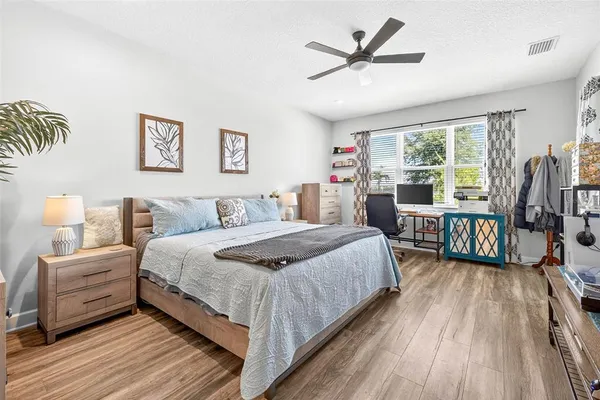 a bedroom with double bed and a large window