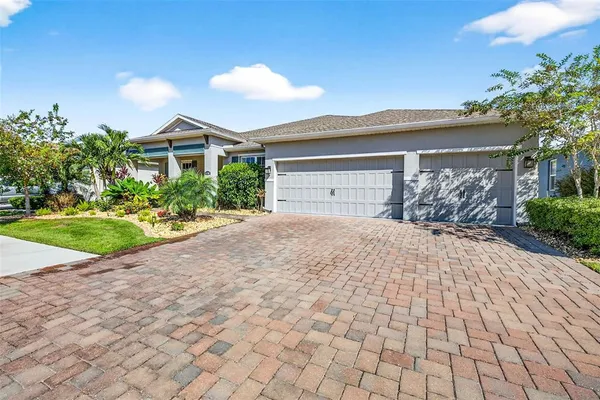 a front view of a house with a yard and a garage
