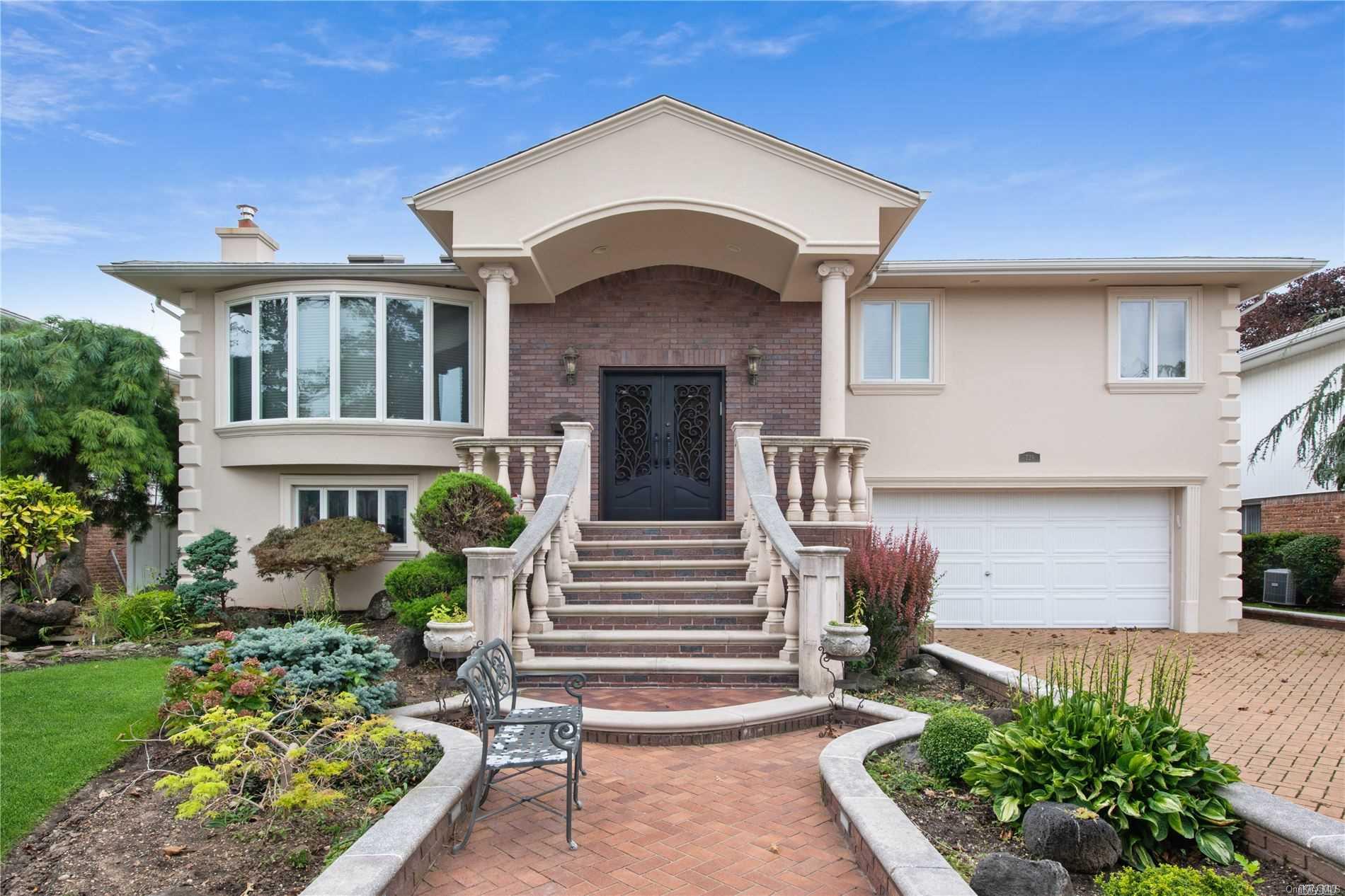 a front view of a house with a garden