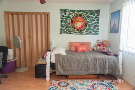 208 West Rader Avenue Ridgecrest, CA 93555 - Photo 11 of 18 a bedroom with a bed and a window
