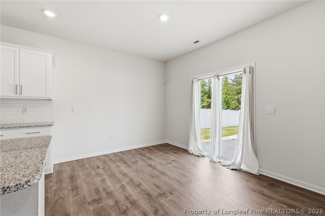 2208 Clydesmill Road Fayetteville, NC 28314 - Photo 16 of 26 an empty room with wooden floor and windows