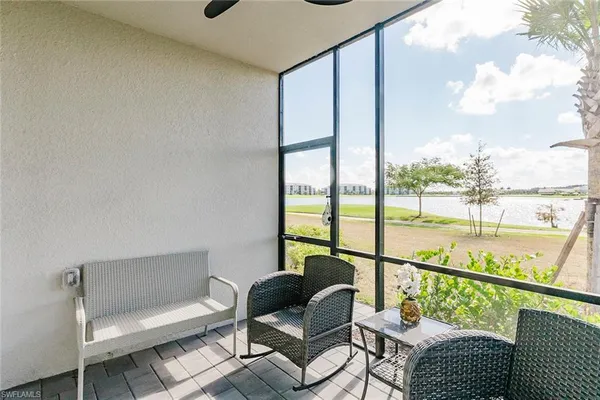 a balcony with furniture and a potted plant