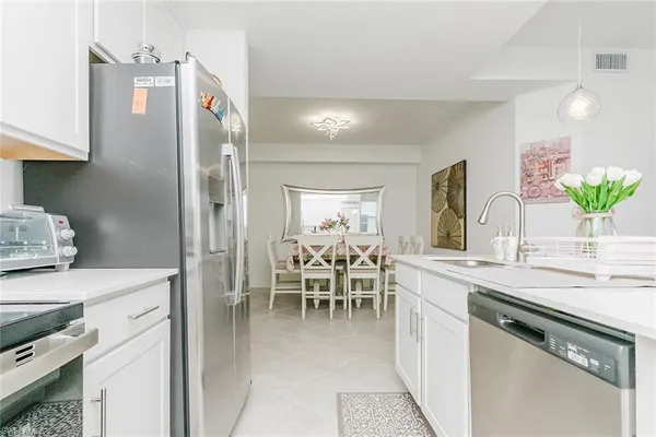 a kitchen with stainless steel appliances a sink stove and cabinets