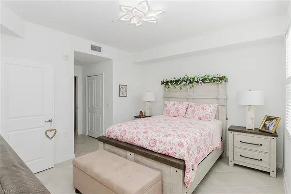 a bedroom with a bed and a chandelier