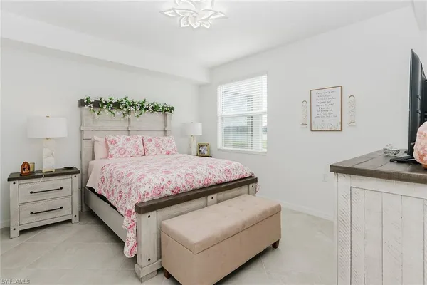 a bed sitting in a bedroom next to a window