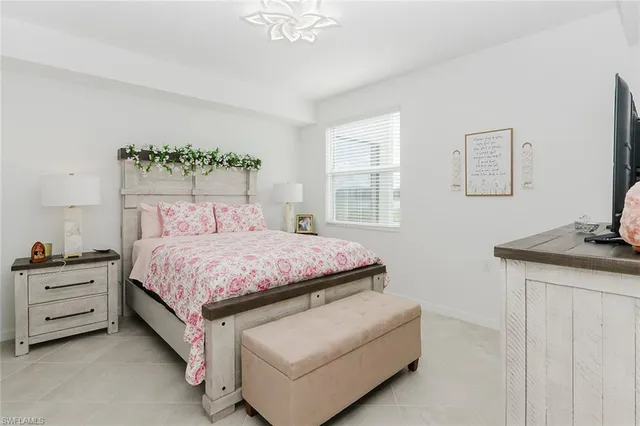 a bed sitting in a bedroom next to a window