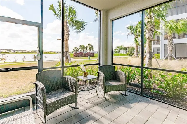 a balcony with furniture and a potted plant