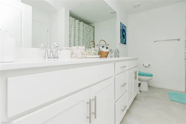 a en suite bathroom with a sink a mirror and a shower