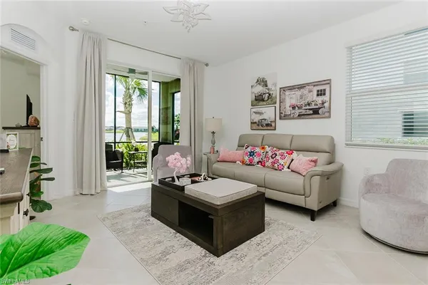 a living room with furniture and a large window