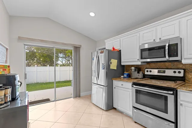 a kitchen with stainless steel appliances a stove a microwave and a sink
