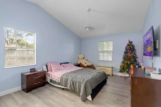 a bedroom with a bed window and potted plant