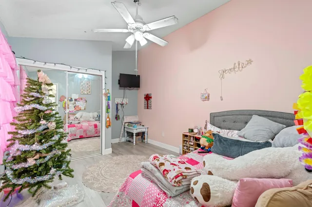 a bedroom with a bed and a chandelier