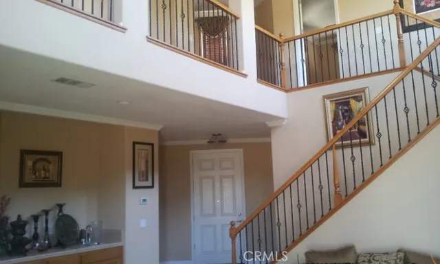 a view of staircase with white walls and a sink