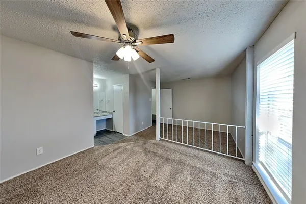 a view of a livingroom with a ceiling fan and window