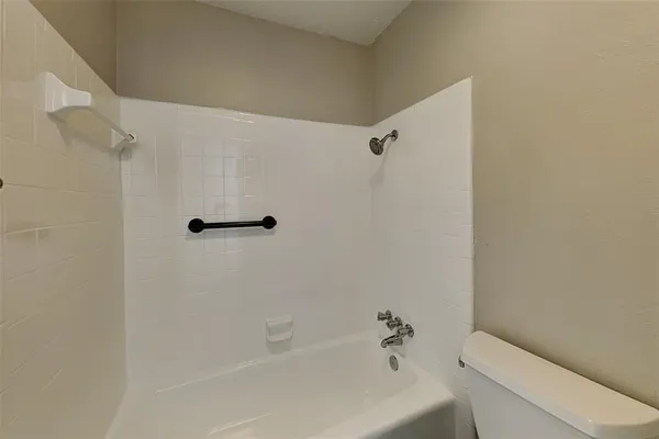 a bathroom with a toilet and a tub